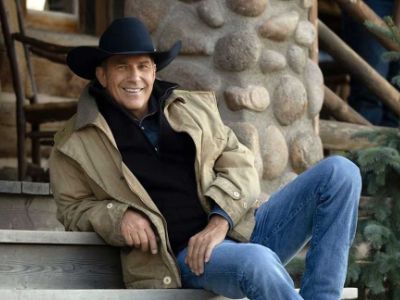 Kevin Costner is wearing a black cowboy hat and denim jeans in the picture.
